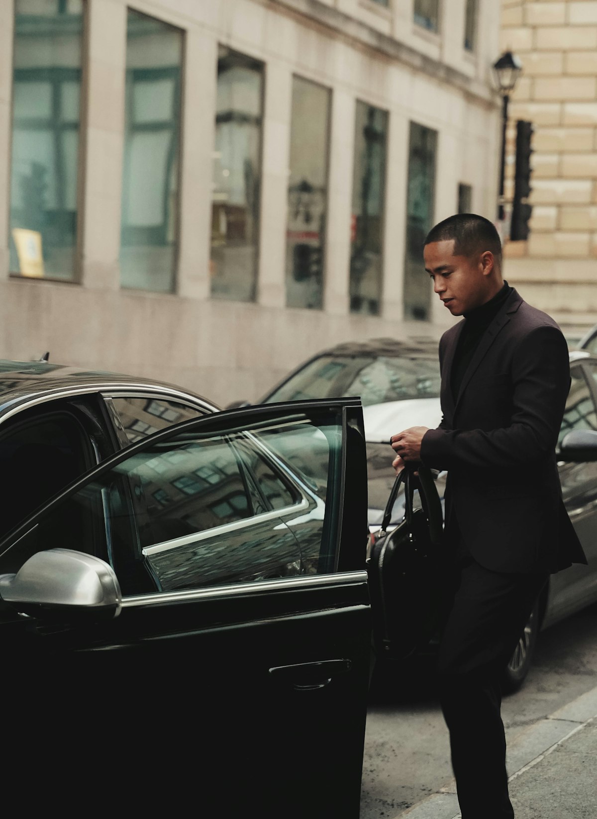 Chauffeur opening the door of an executive car